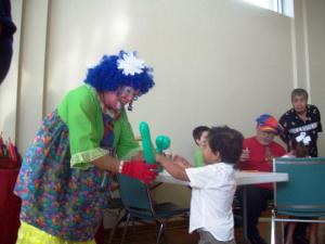 Young boy enjoys a balloon at 2012 Waffle Breakfast