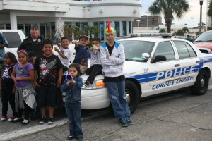 Corpus Christi Police Senior Officer Diaz stood with nearby children at John Sartain Street and Shoreline excited to see the parade