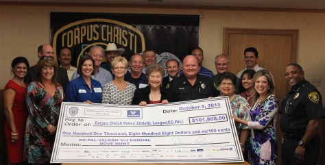 Senior Officer David Morris stands with Chief Floyd Simpson and accepted a check to support the Corpus Christi Police Athletic League.