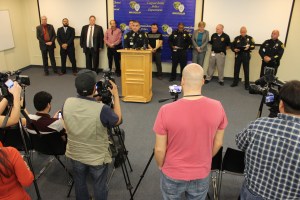 Corpus Christi Chief of Police and his staff stand with Nueces County District Attorney Mark Skurka to deliver the news of the arrest of two men for Capital Murder